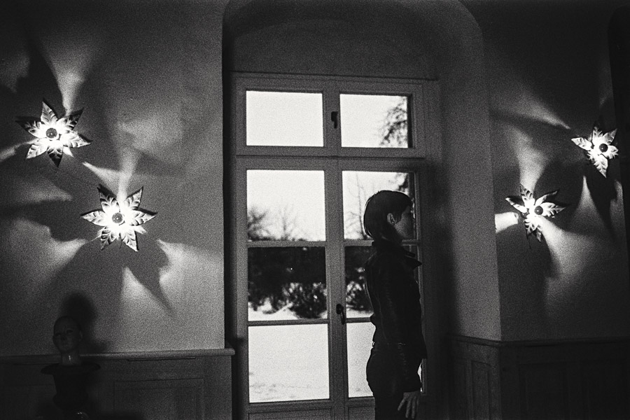 Schwarzweiß-Fotografie, Frau am Fenster mit Stern-Lichtern, Kunstfotografie