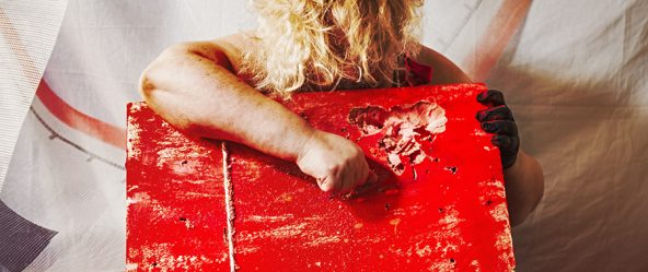 Rückenansicht mit blondem Haar über rotem Nagelbrett, Faust auf beschädigtem Holz, Canon 6D, abstrakte Bondage-Inszenierung Vogelfrei