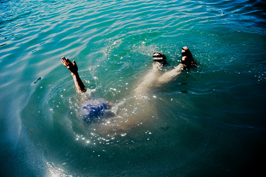 person taucht rücklings unter wasser, nur arm und füße ragen heraus, konzeptfotografie see fischtanz-serie, canon 6d