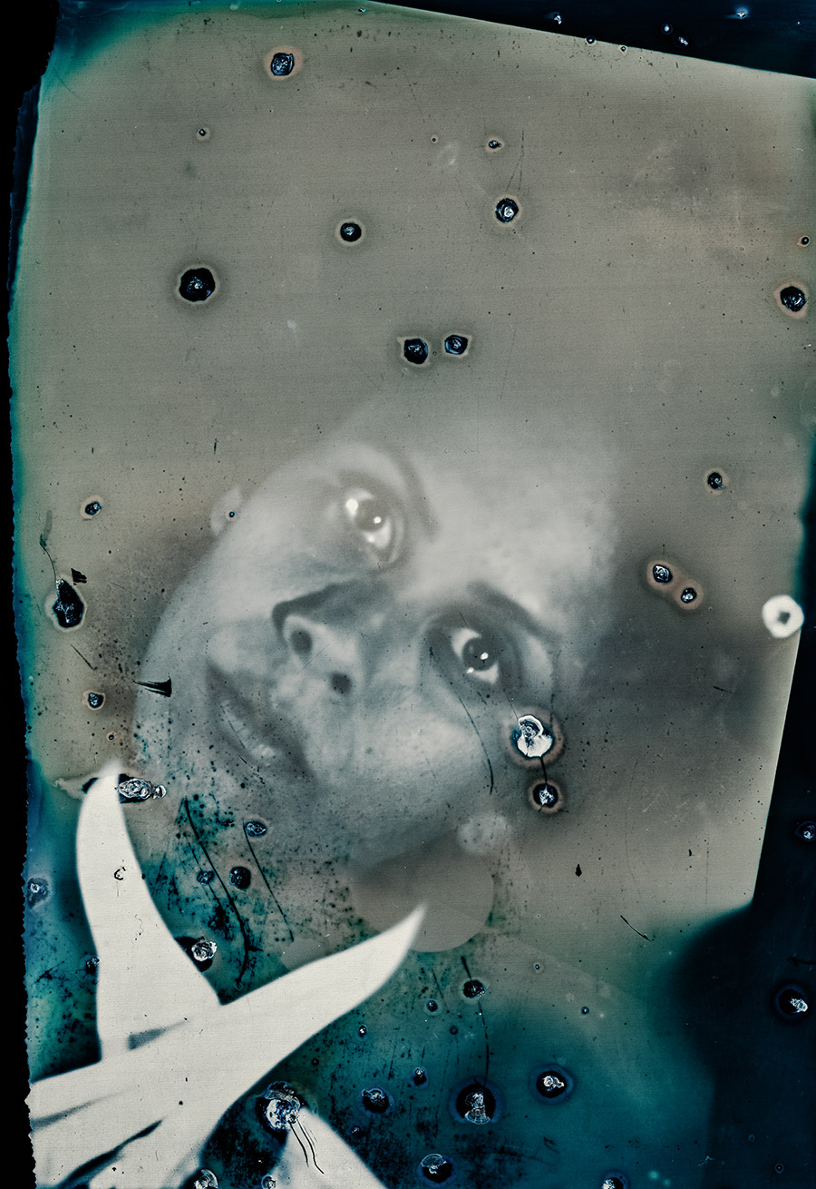 Stark beschädigtes analoges Porträt mit Blasen und Flecken auf der Fotoemulsion, Blick nach oben, weißes Kleidungsdetail, konzeptuelle Fotografie über Zerfall und Emotion